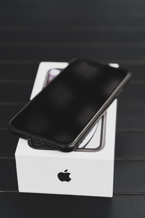 An Apple phone on a box with Apple’s logo
